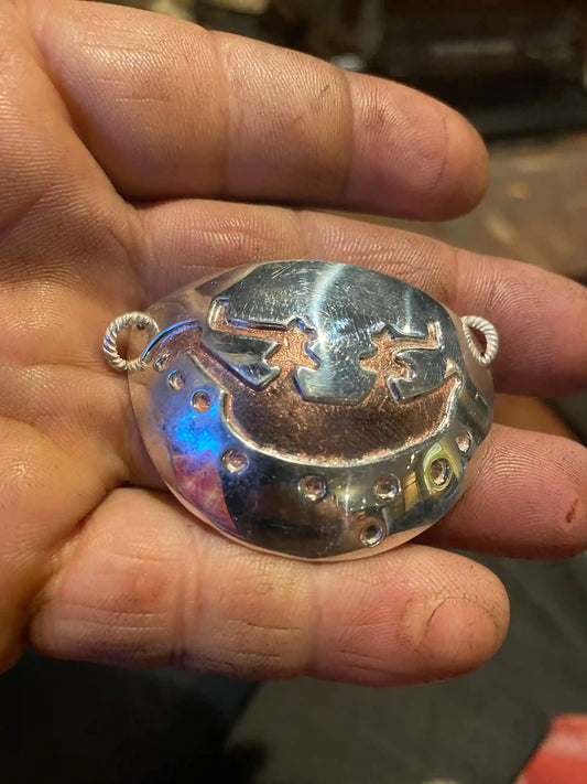 hand holding Boat People Pictograph Necklace pendant